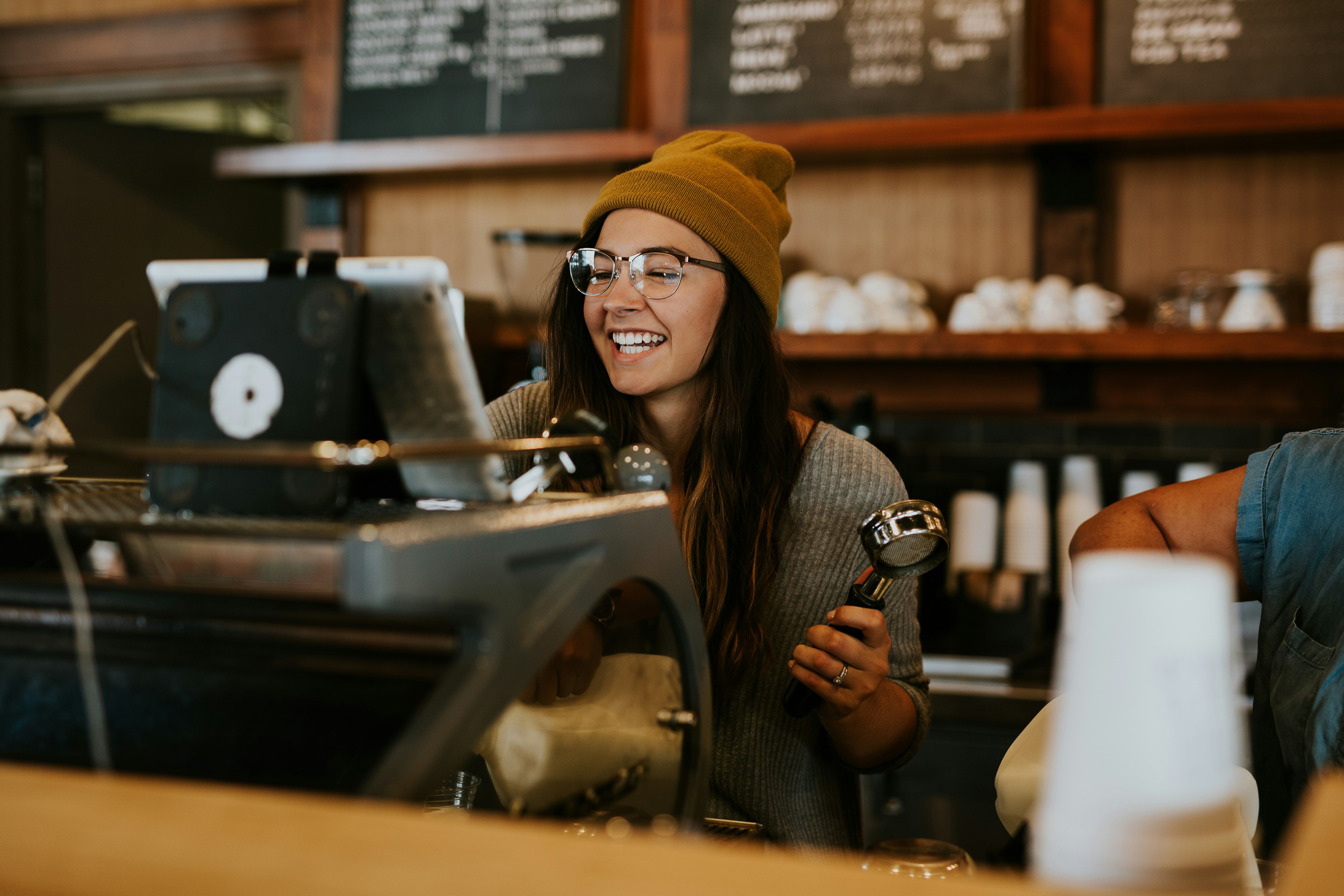 A barista at work behind a café counter